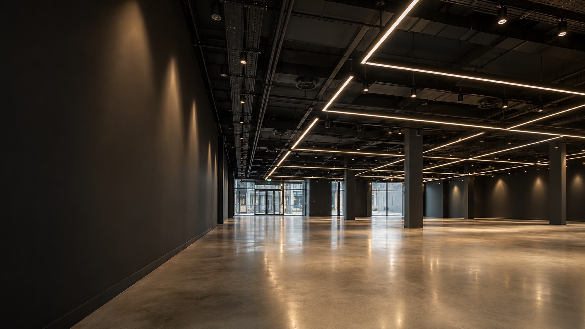 Architectural linear LED lighting in a large empty commercial unit with polished concrete floor