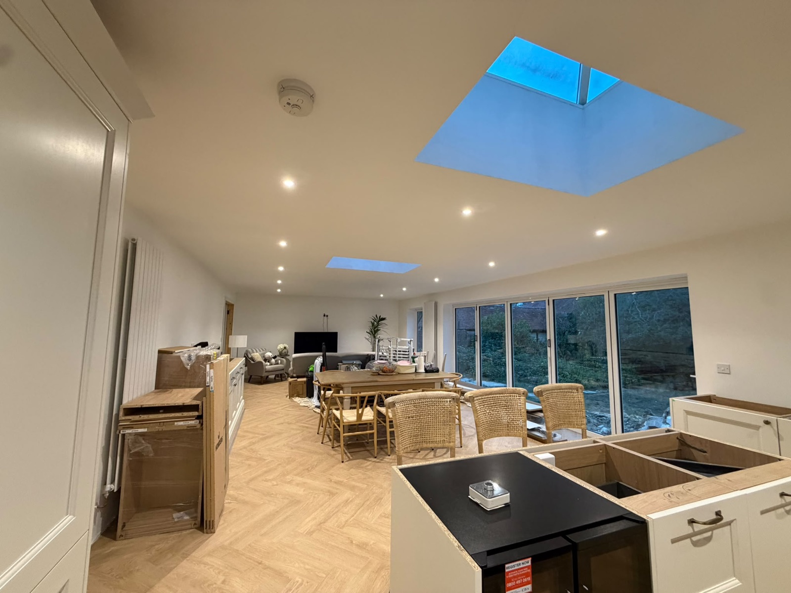 Open-plan kitchen diner with a lit roof lantern and downlights