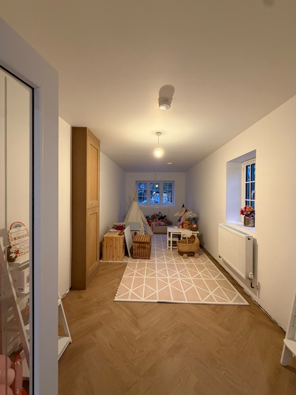 Landing and hallway with pendant lighting and herringbone flooring