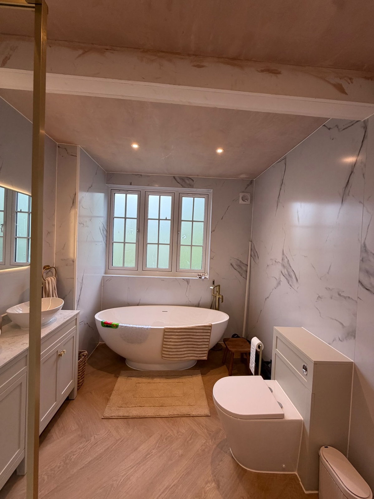 Marble en-suite with freestanding bath, downlights and shutters