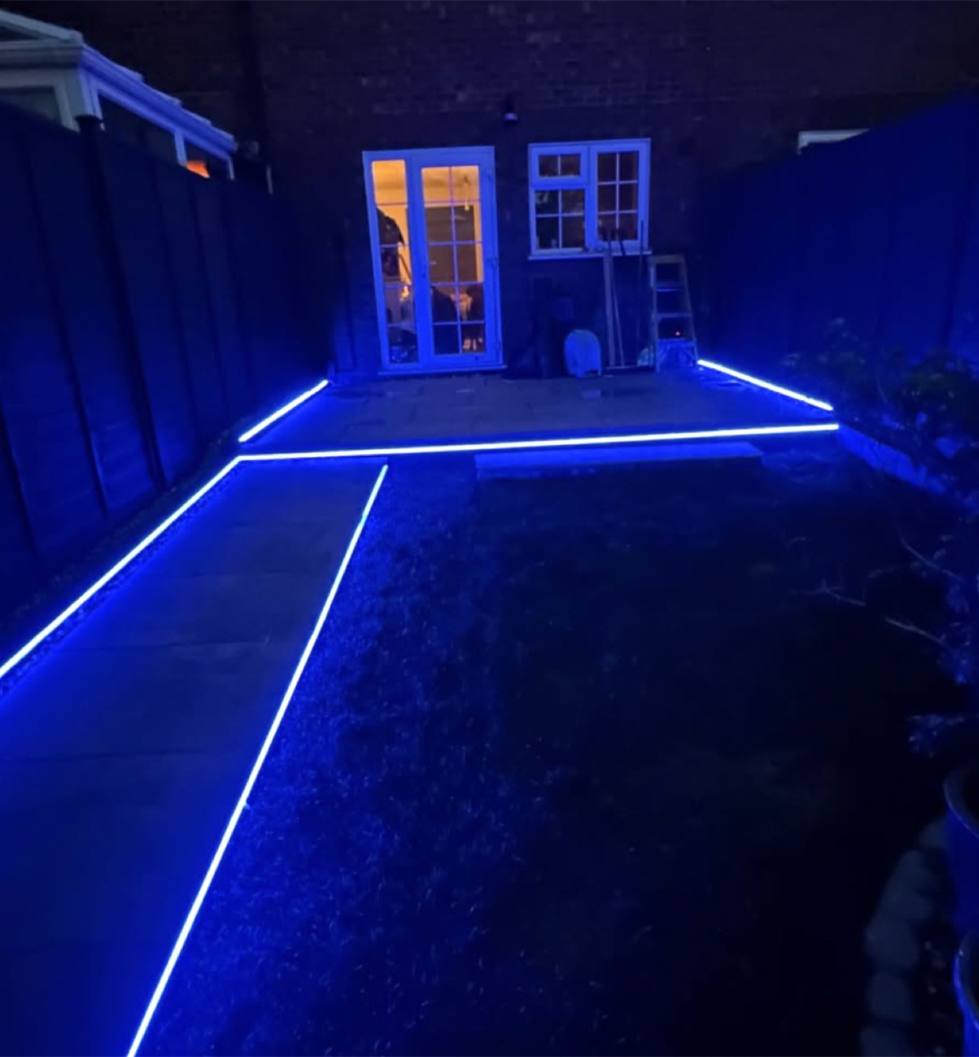 LED strip lighting running along a garden path at night